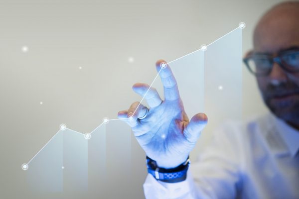 Businessman pointing his finger to a growth graph